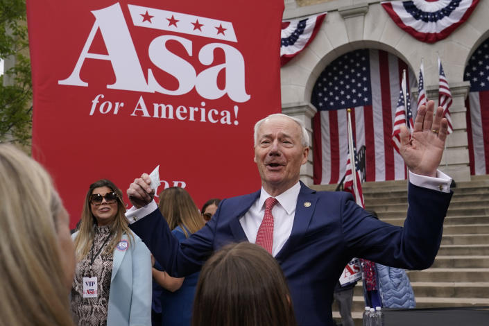 Former Arkansas Gov. Asa Hutchinson reacts to receiving a campaign contribution after formally announcing his Republican campaign for president, Wednesday, April 26, 2023, in Bentonville, Ark.. (AP Photo/Sue Ogrocki)